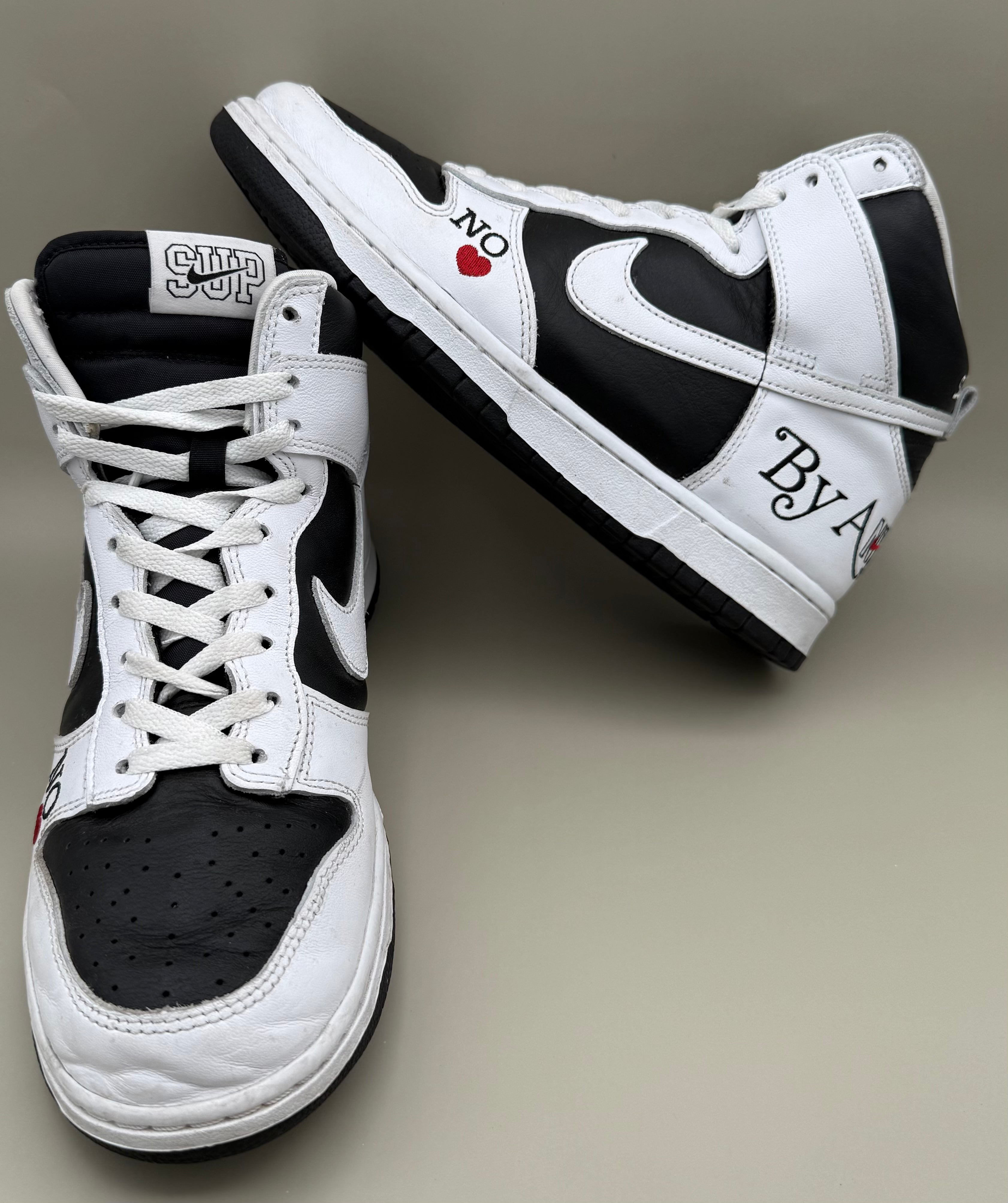 Nike Dunk High, designed in collaboration with or styled after Supreme's "By Any Means" theme.