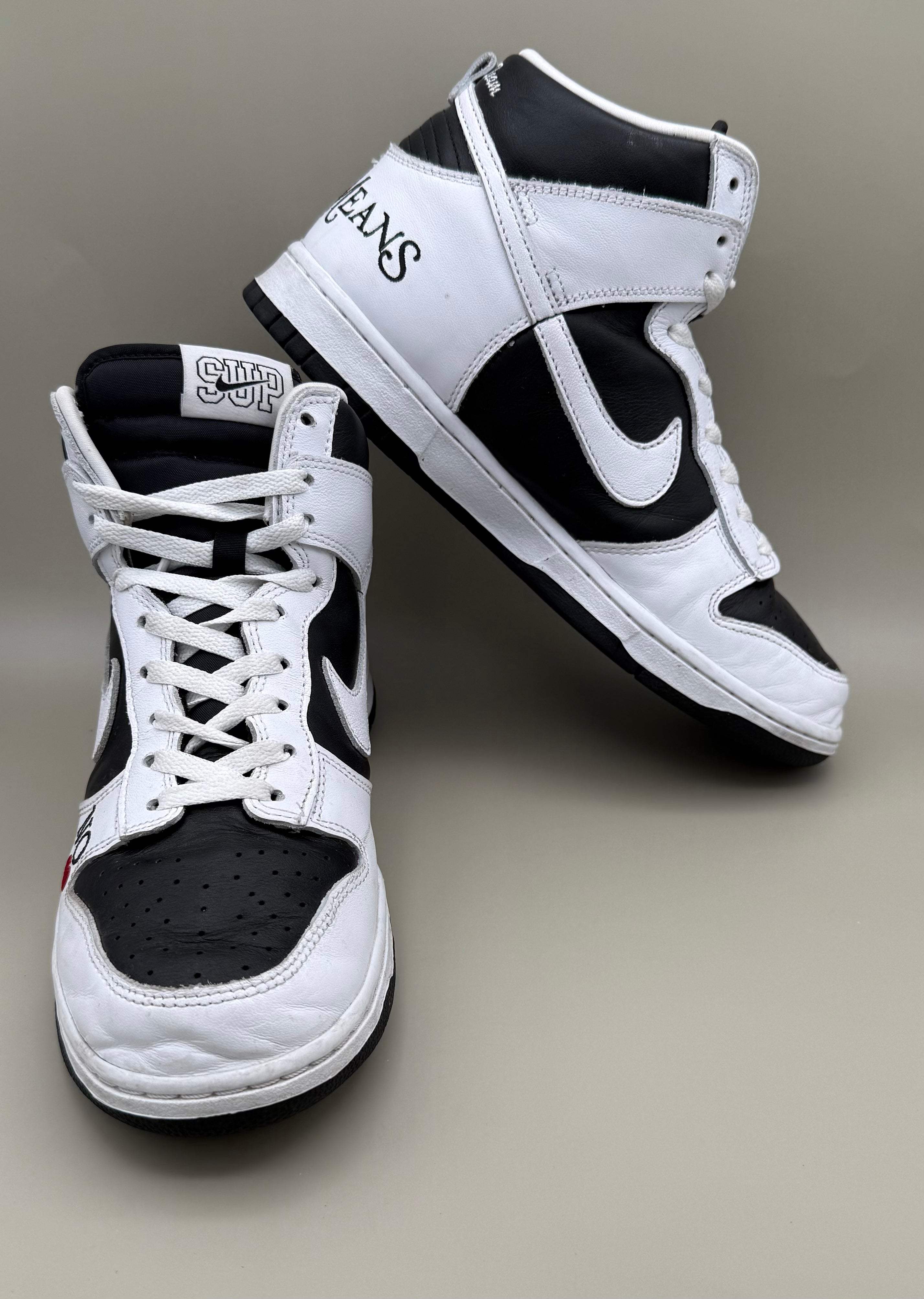 Nike Dunk High, designed in collaboration with or styled after Supreme's "By Any Means" theme.