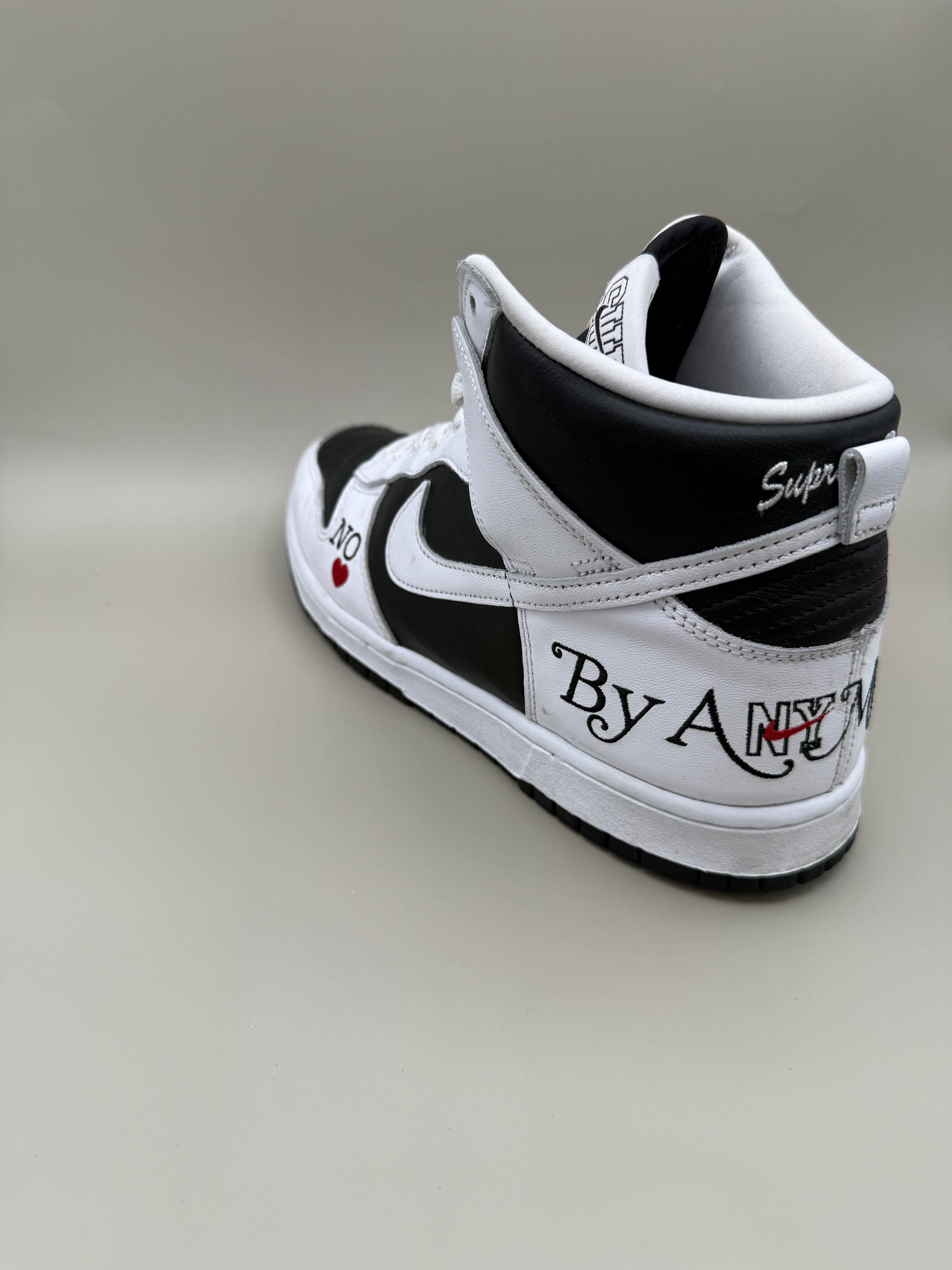 Nike Dunk High, designed in collaboration with or styled after Supreme's "By Any Means" theme.