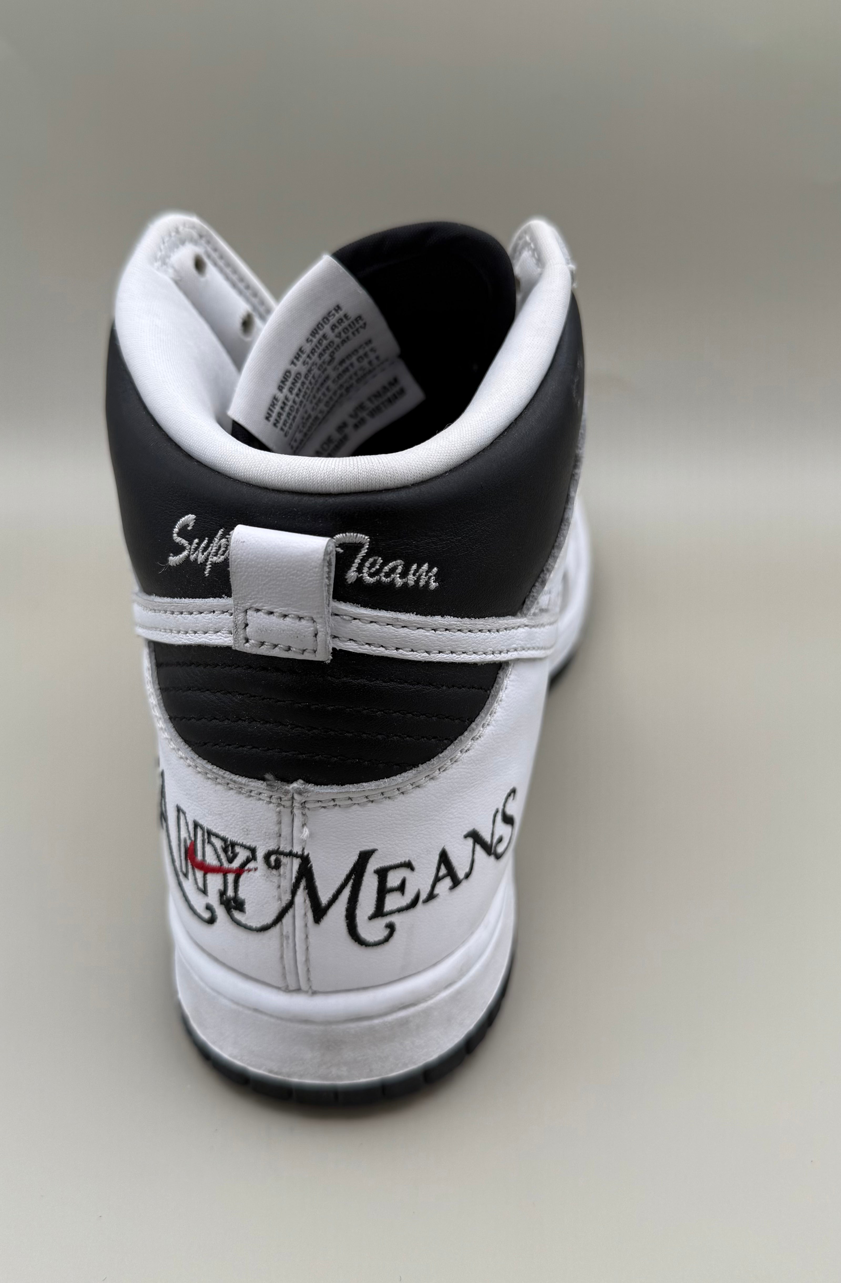 Nike Dunk High, designed in collaboration with or styled after Supreme's "By Any Means" theme.